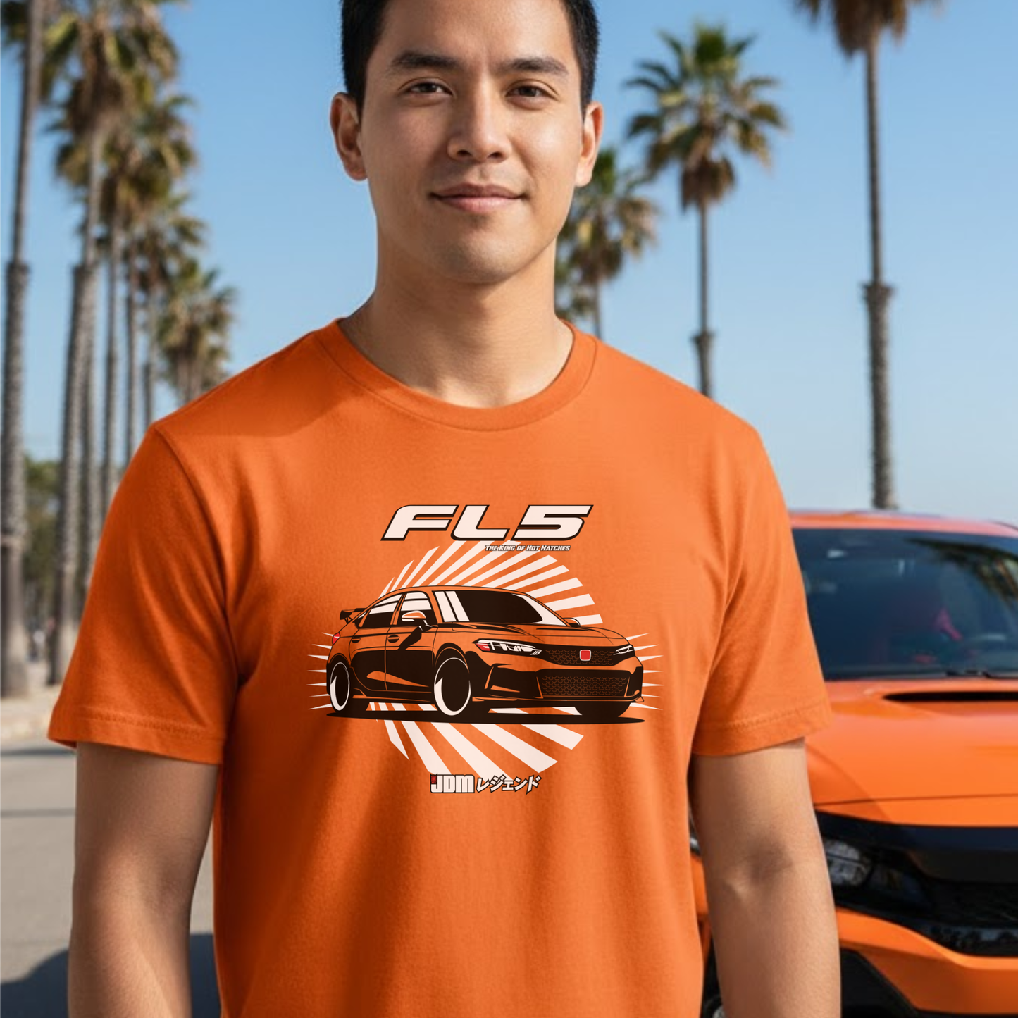 Person wearing an orange t-shirt with a car graphic and 'FL5' text, standing in front of palm trees and an orange car.