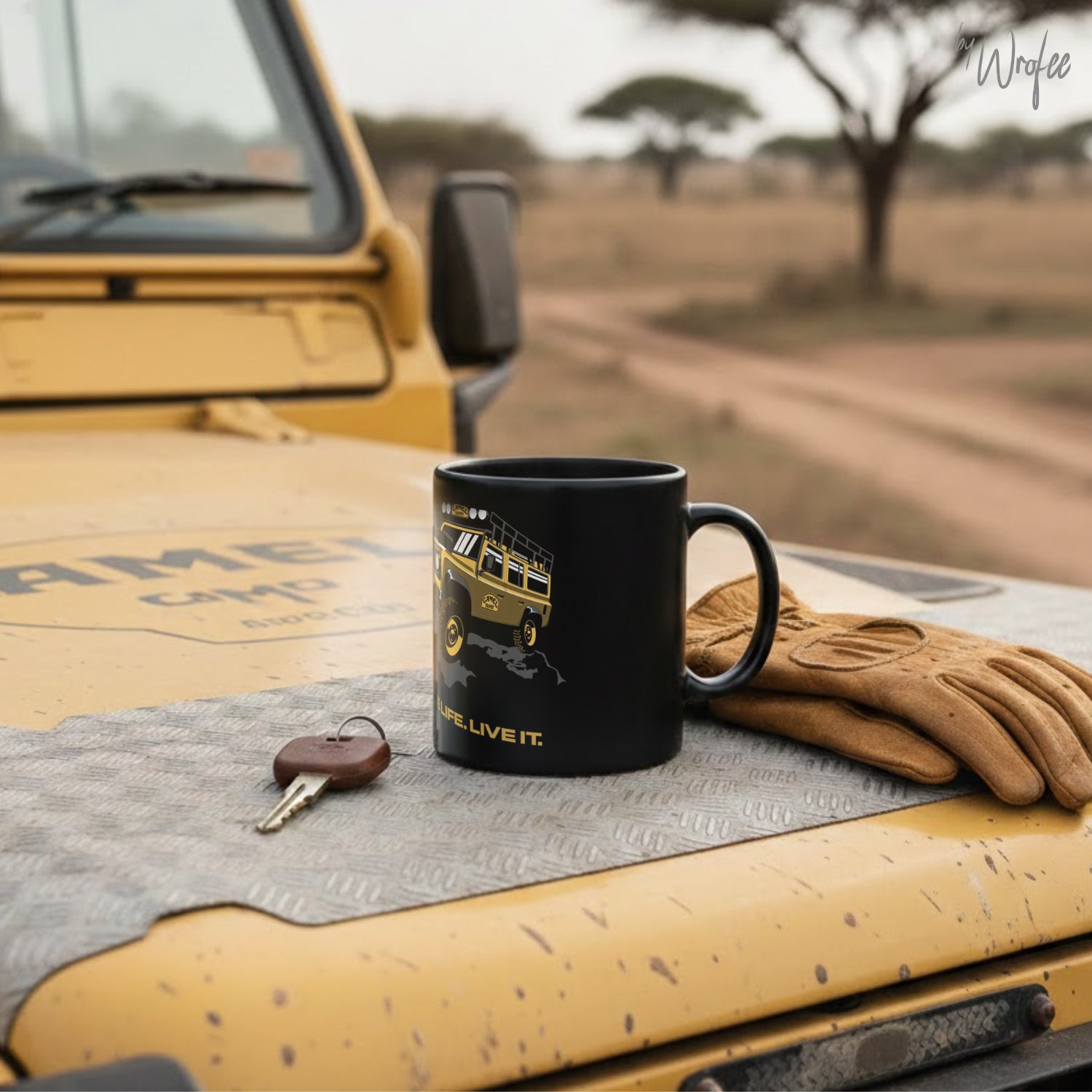 Black mug with a off road vehicle design on a yellow truck in a desert setting