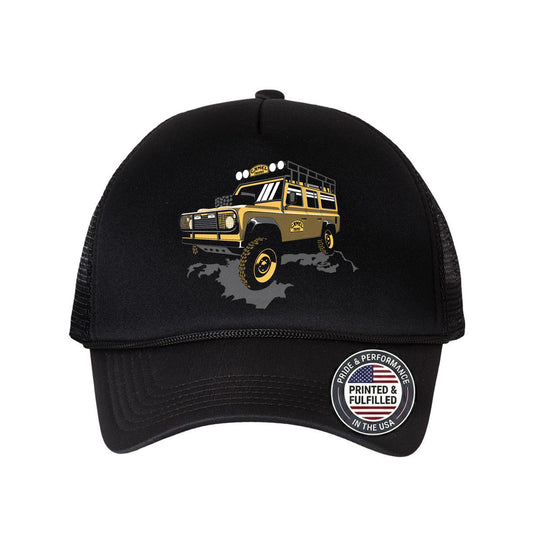 Black cap with a Camel Trophy Defender SUV and 'Printed & Fulfilled in the USA' badge on a white background