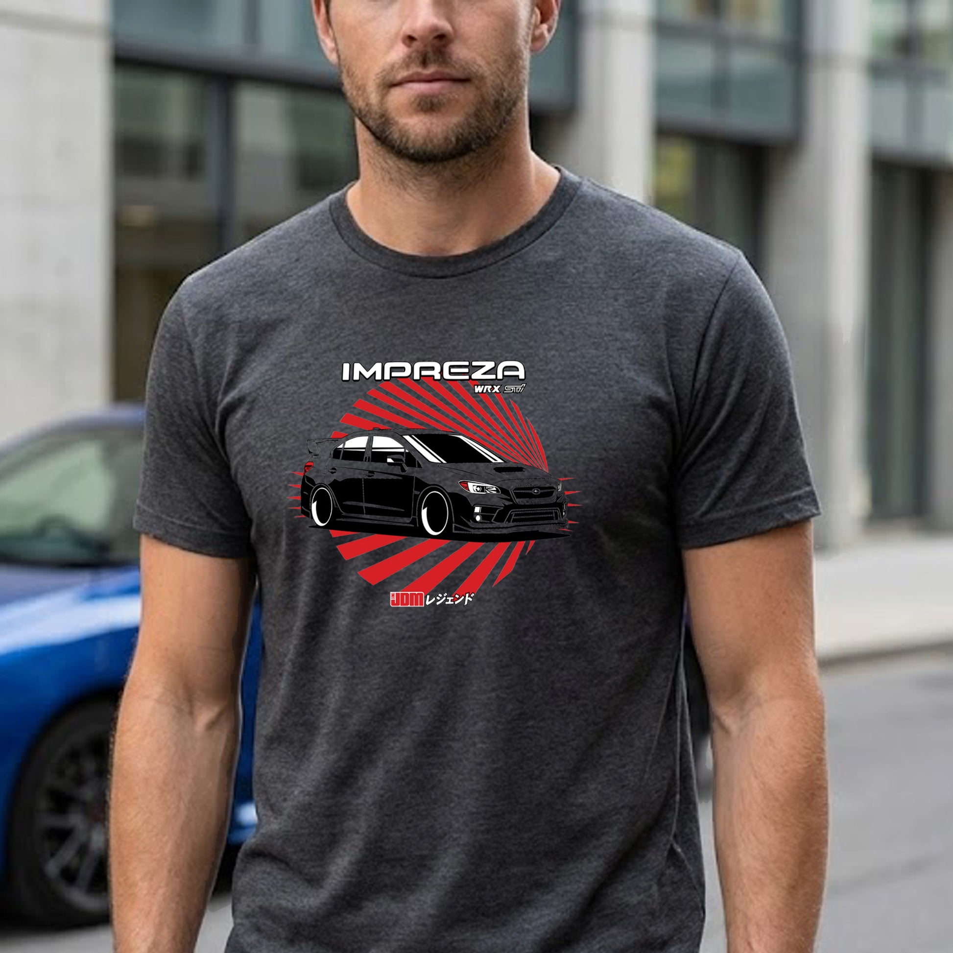 Man wearing a dark gray t-shirt with a car graphic and 'Impreza' text, standing outdoors.
