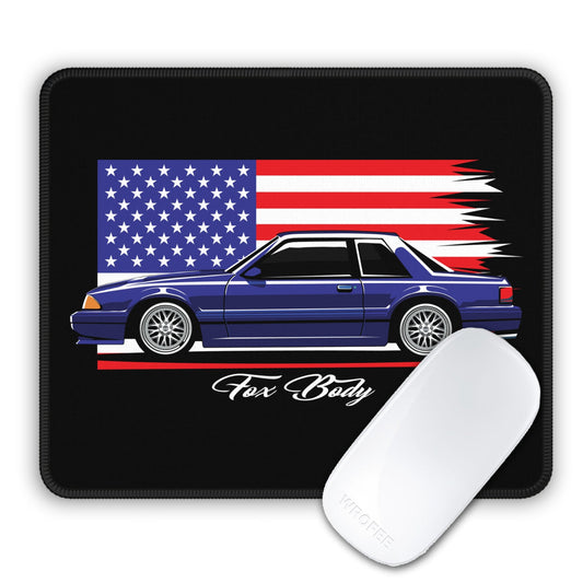 Mouse pad with a car design featuring an American flag and 'Fox Body' text, accompanied by a white mouse.