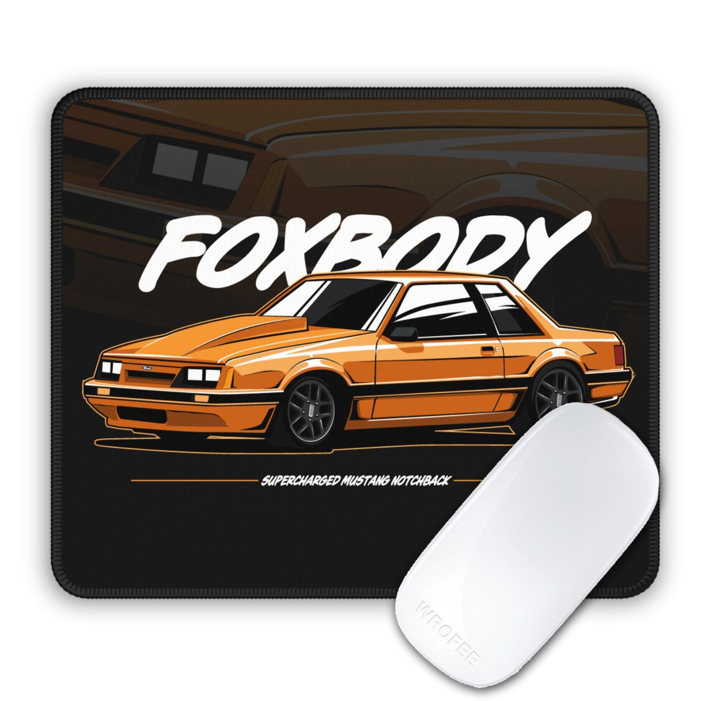 Mouse pad with orange car design and 'FOXBODY' text on a black background