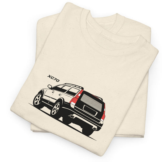 A folded cream-colored t-shirt featuring a graphic print of a Volvo XC70 SUV in black, white, and red, with the model name 'XC70' printed in black above the vehicle.