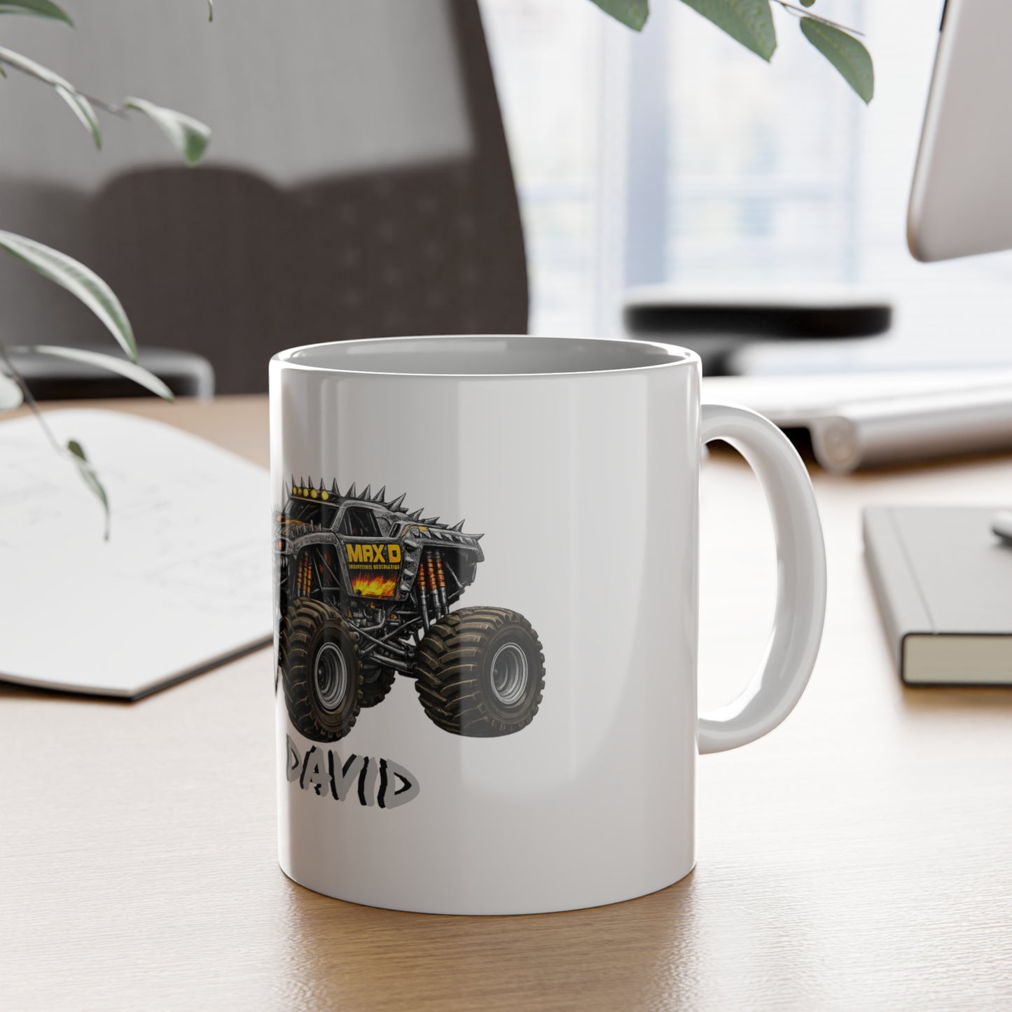 White mug with a monster truck design on a desk